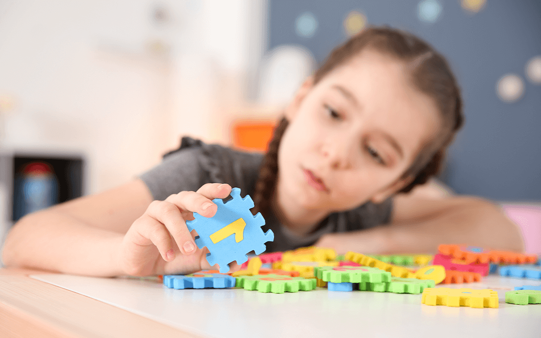 child playing with foam numbers and letters