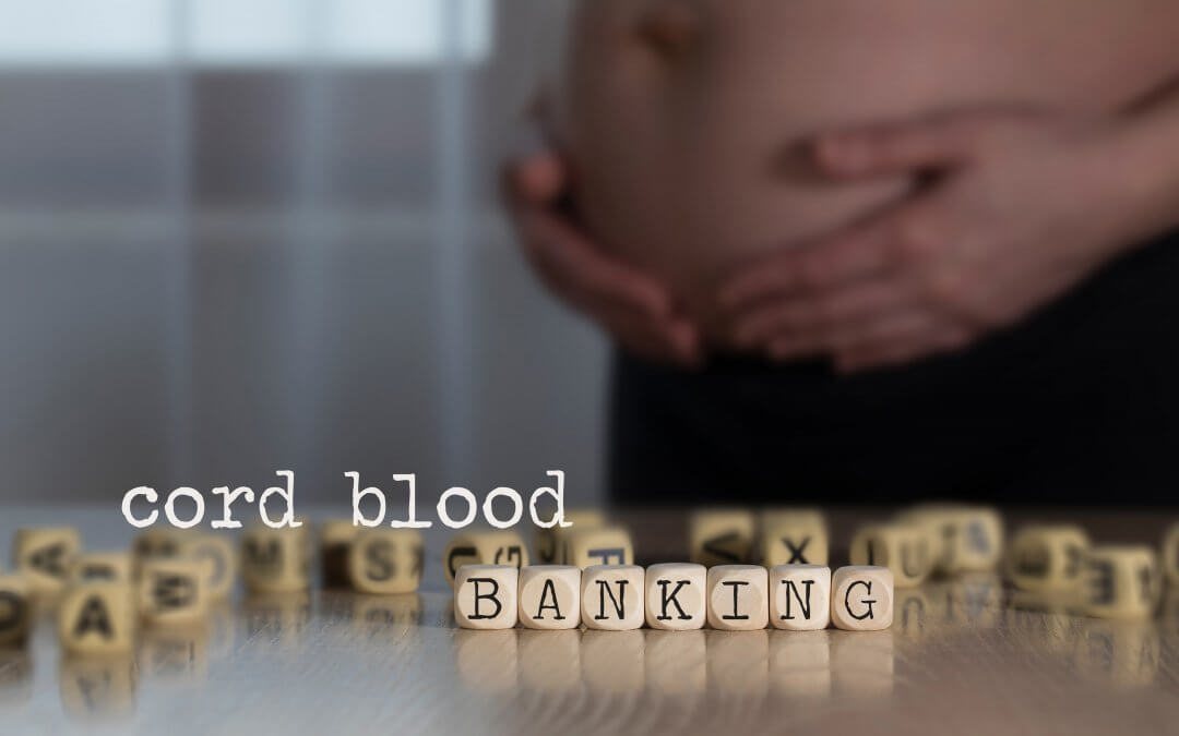 Words CORD BLOOD BANKING composed of wooden letters. Pregnant woman in the background