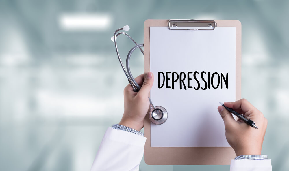 a doctor holds a clipboard with the word depression written on it, attempting to find a therapy