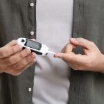 Person managing their type 2 diabetes with a glucose monitor