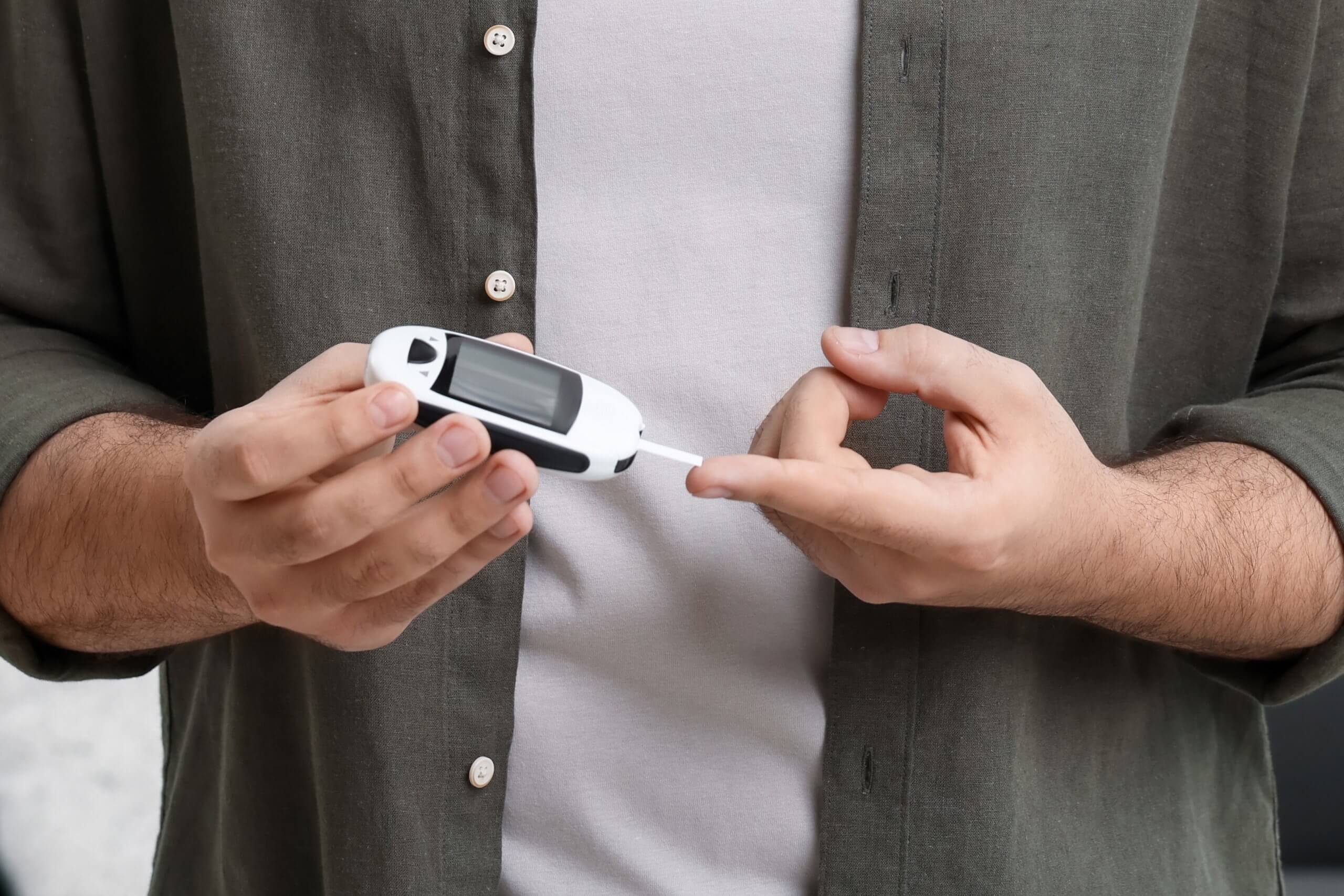 Person managing their type 2 diabetes with a glucose monitor