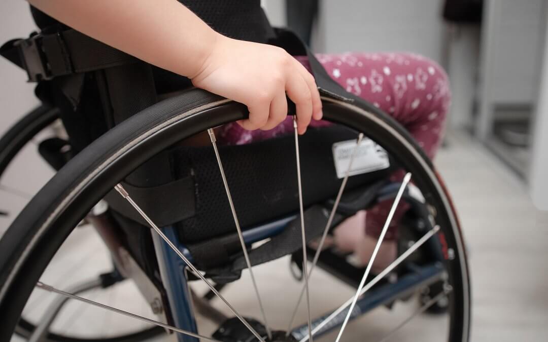 A photo of a child in a wheelchair.
