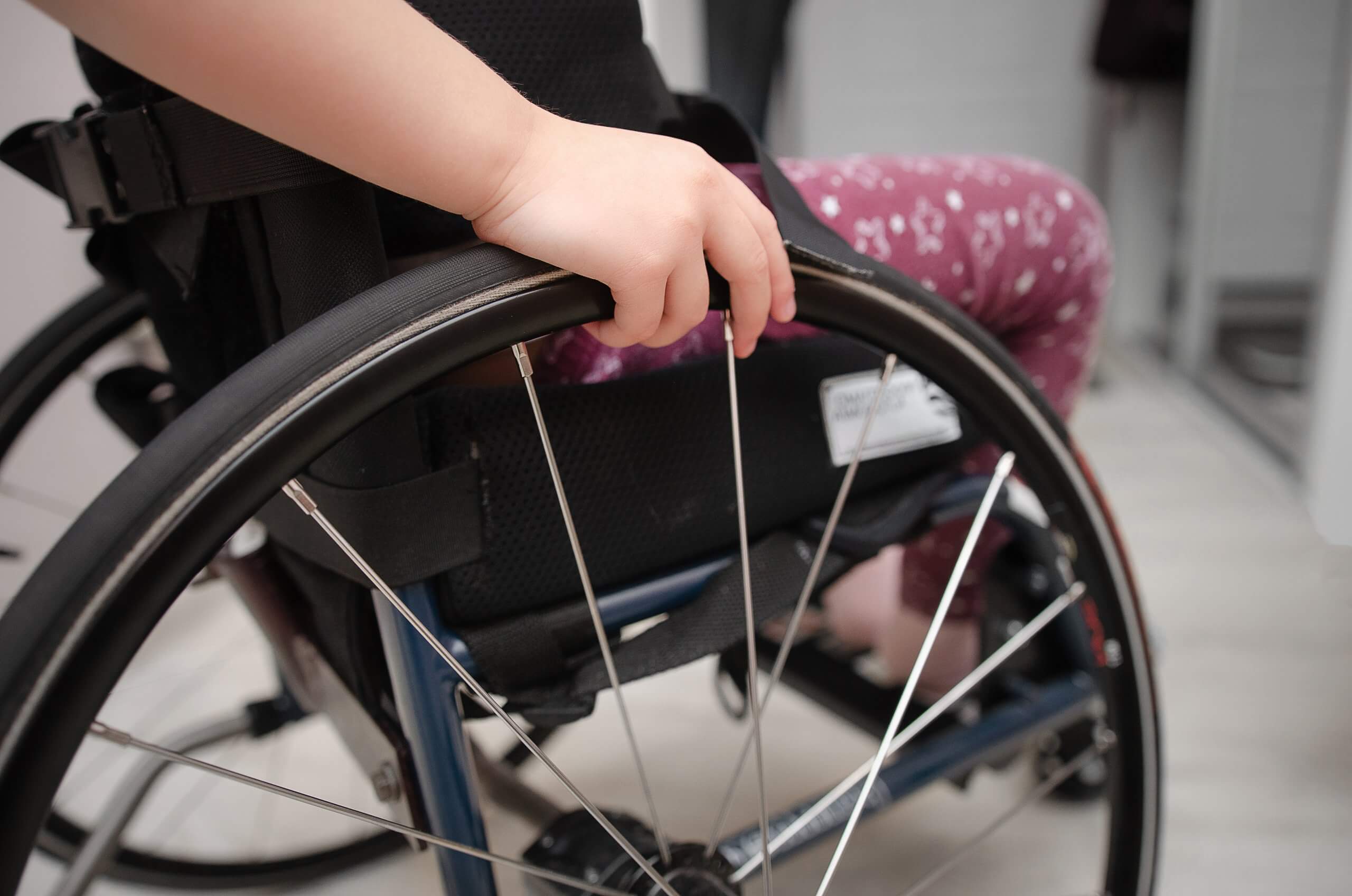 A photo of a child in a wheelchair.
